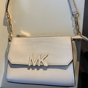 Michael Kors Vanilla Florence Crossbody Chain link attached to leather strap.